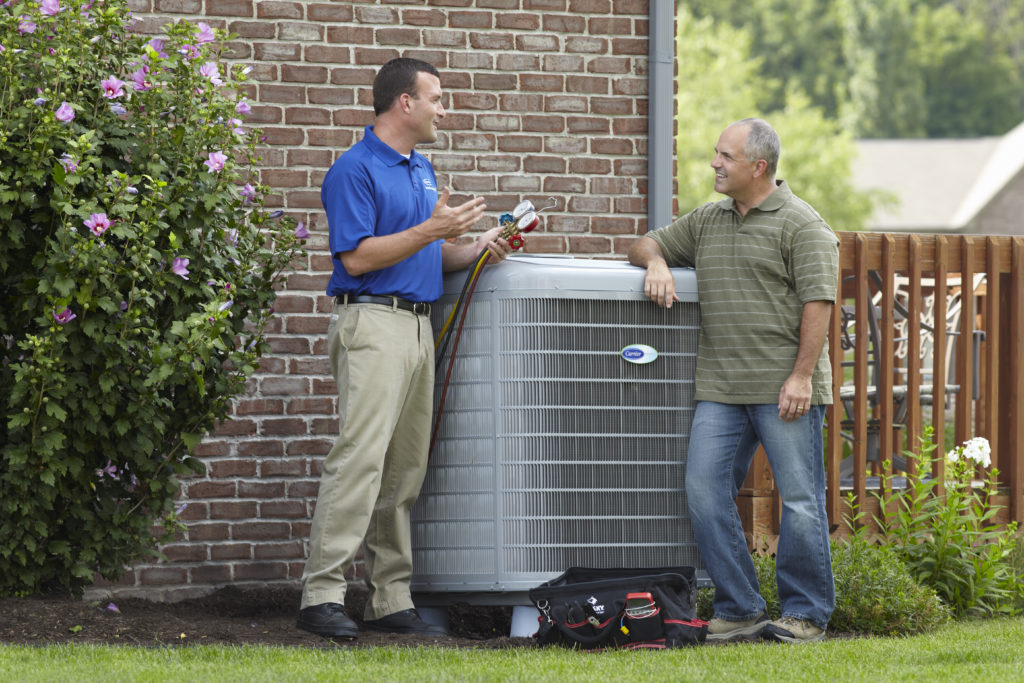Carrier AC unit with homeowner and HVAC technician 