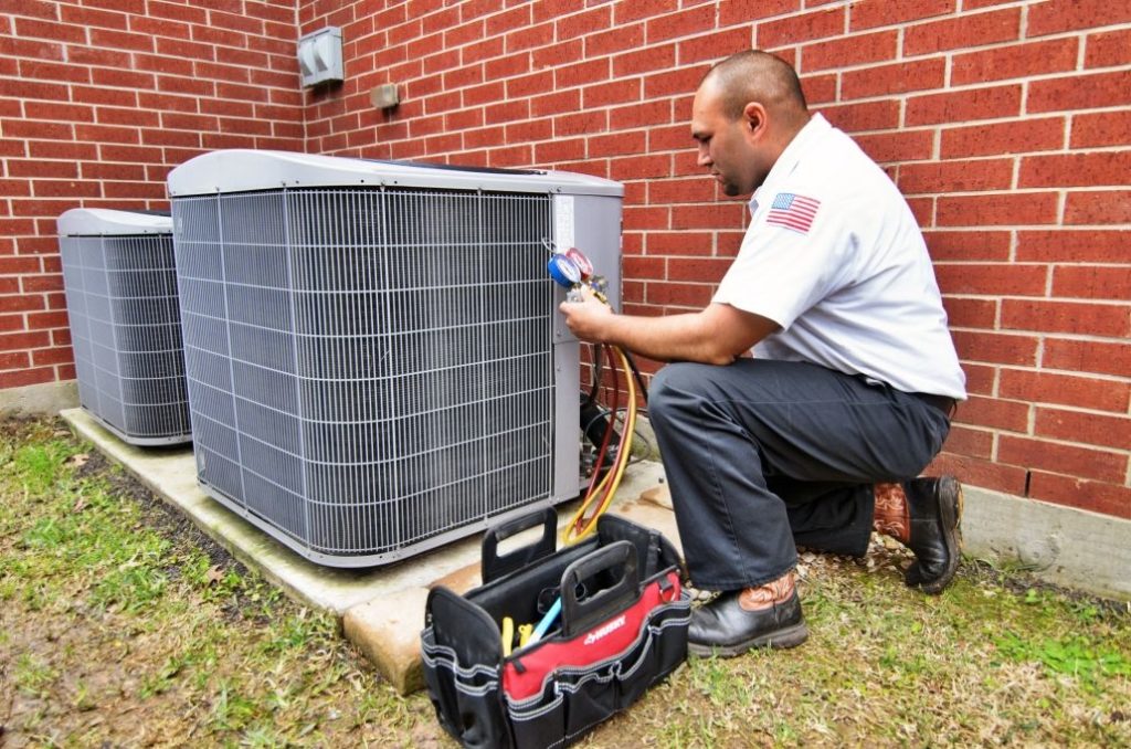 HVAC technician performing an AC maintenance service