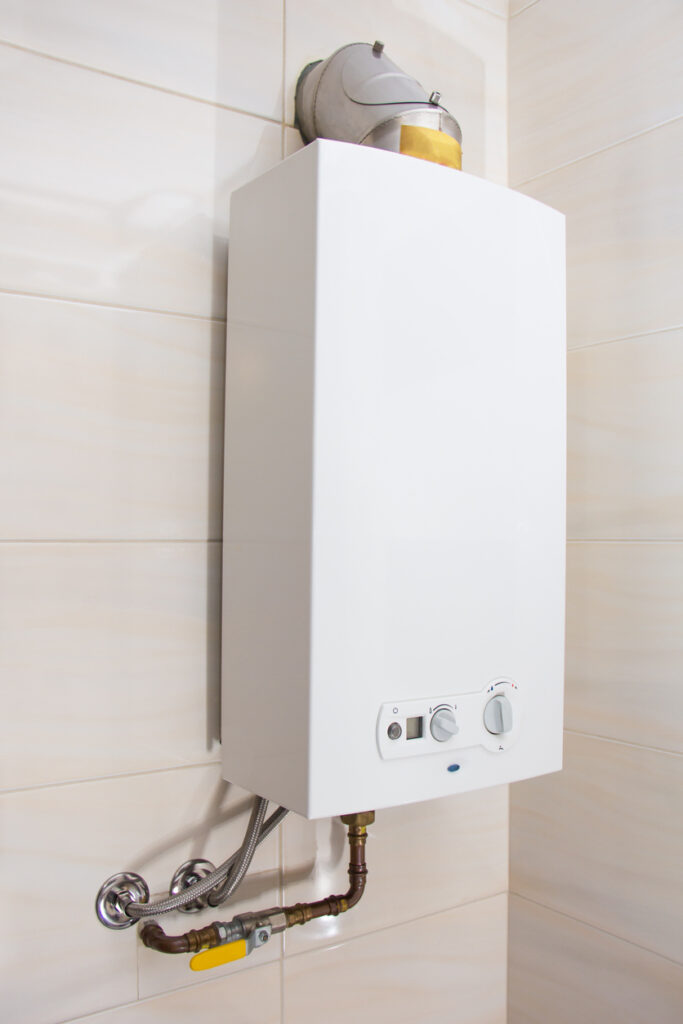 gas tankless water heater mounted on bathroom wall