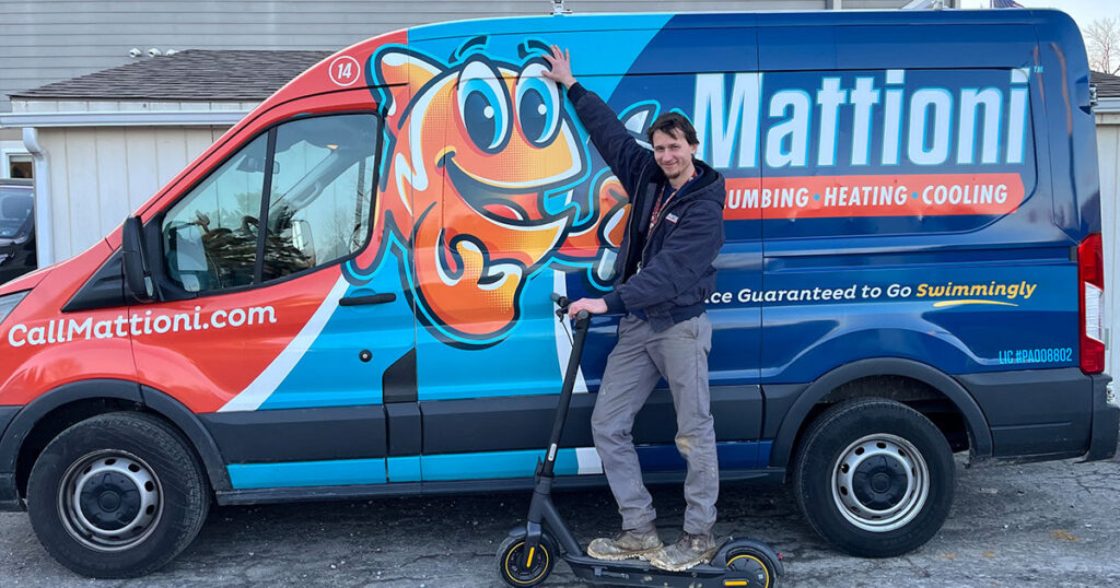 A Mattioni team member on a scooter in front of the Mattioni service truck