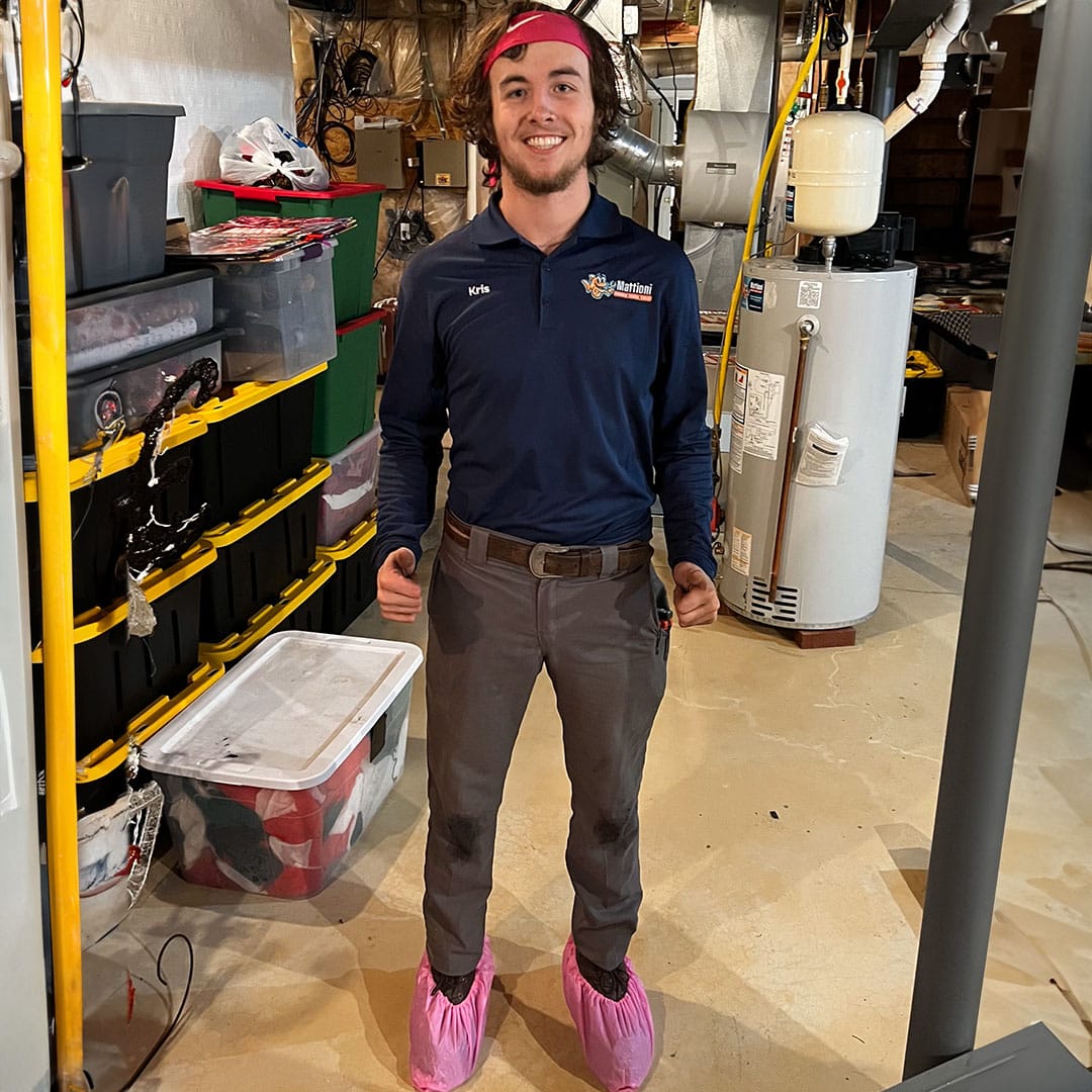 Mattioni employee in a residence wearing booties giving the thumbs up
