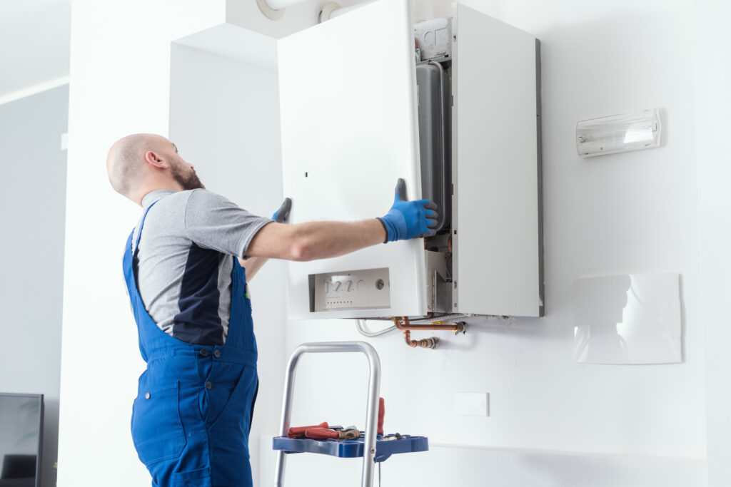 Professional doing a boiler installation at PA home