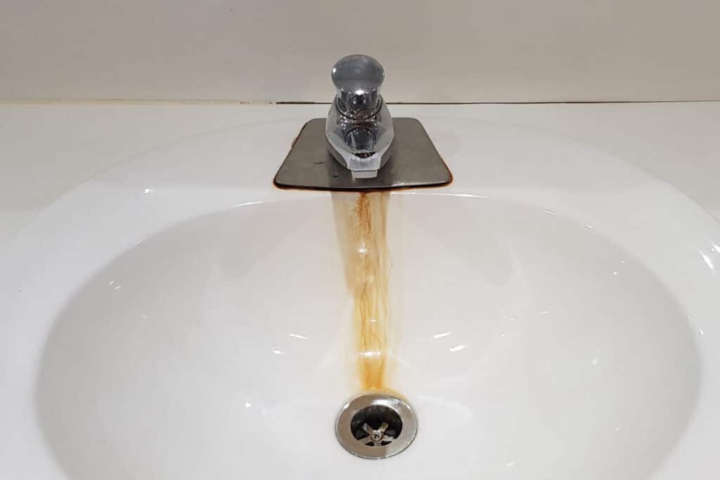 Rusty leaking tap and sink 