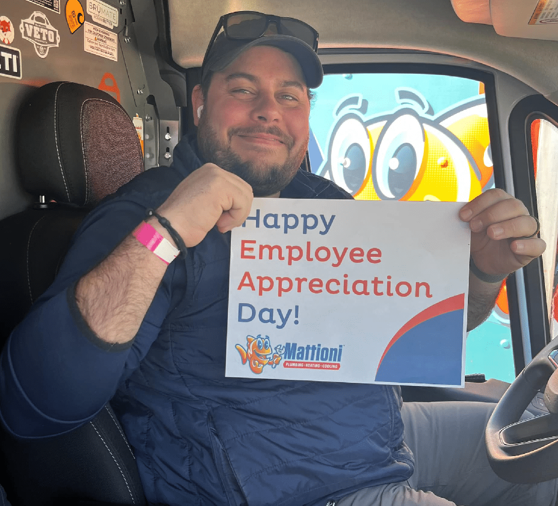 Mattioni employee holding an Employee Appreciation Day sign