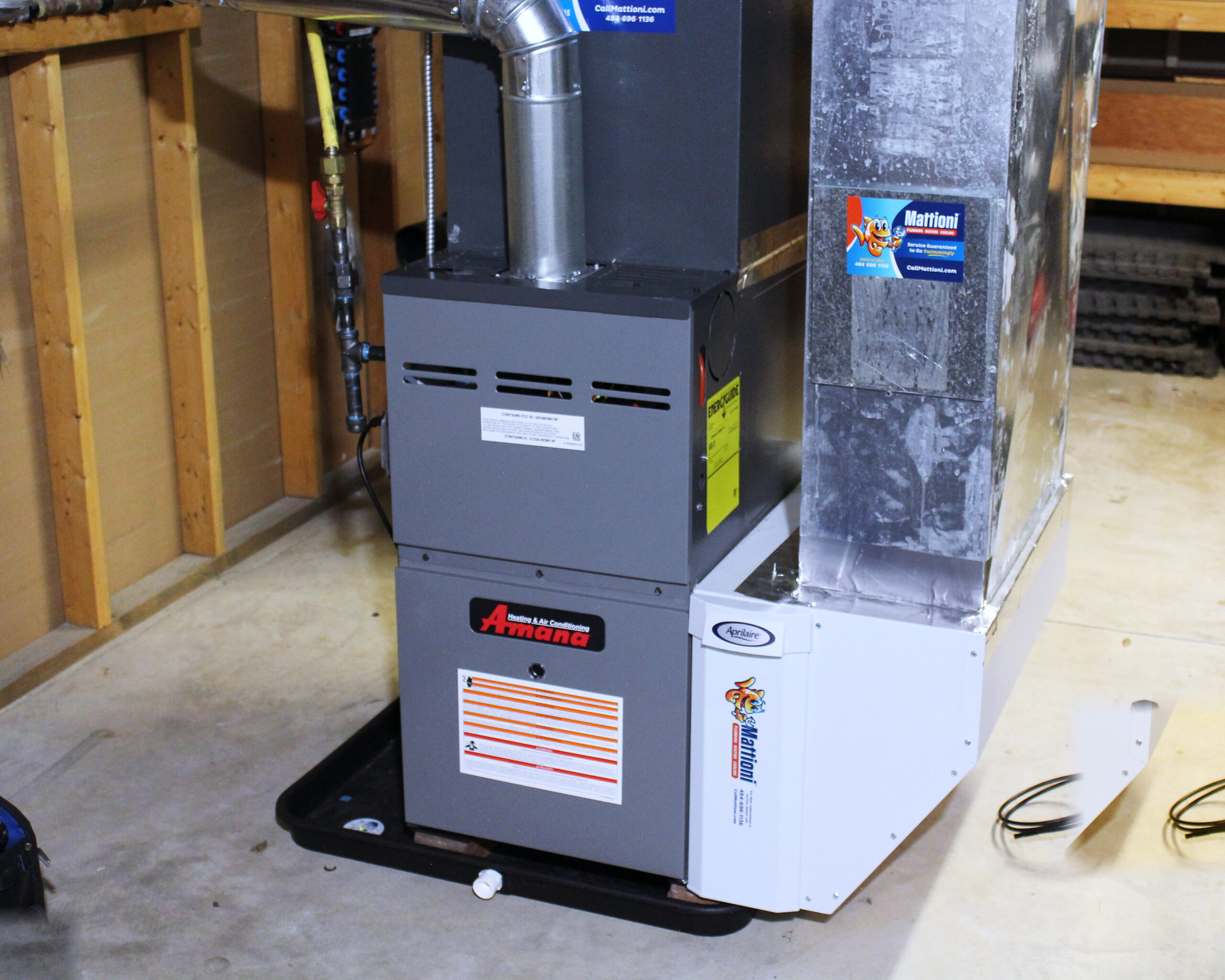 A newly installed Amana furnace with a whole-home humidifier in a basement